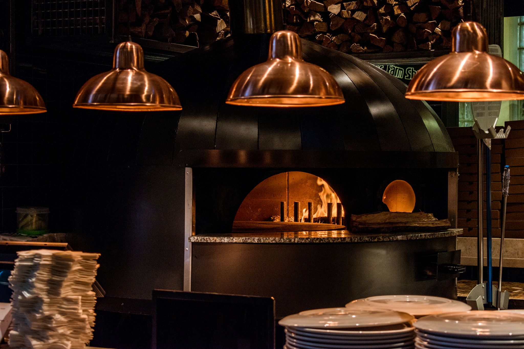 Photo of Old school pizza oven with fire burning in it. Time Out Market in Lisbon, Portugal.