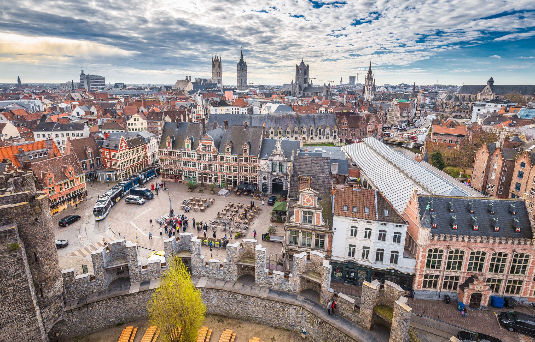 Photo of aerial panoramic view ofthe historic city of Ghent with famous medieval Gravensteen Castle on a beautiful sunny day with blue sky and clouds in summer, Belgium.