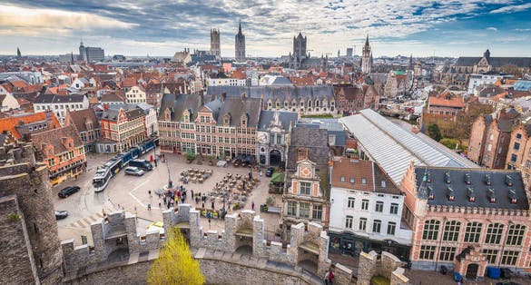 Photo of aerial panoramic view ofthe historic city of Ghent with famous medieval Gravensteen Castle on a beautiful sunny day with blue sky and clouds in summer, Belgium.