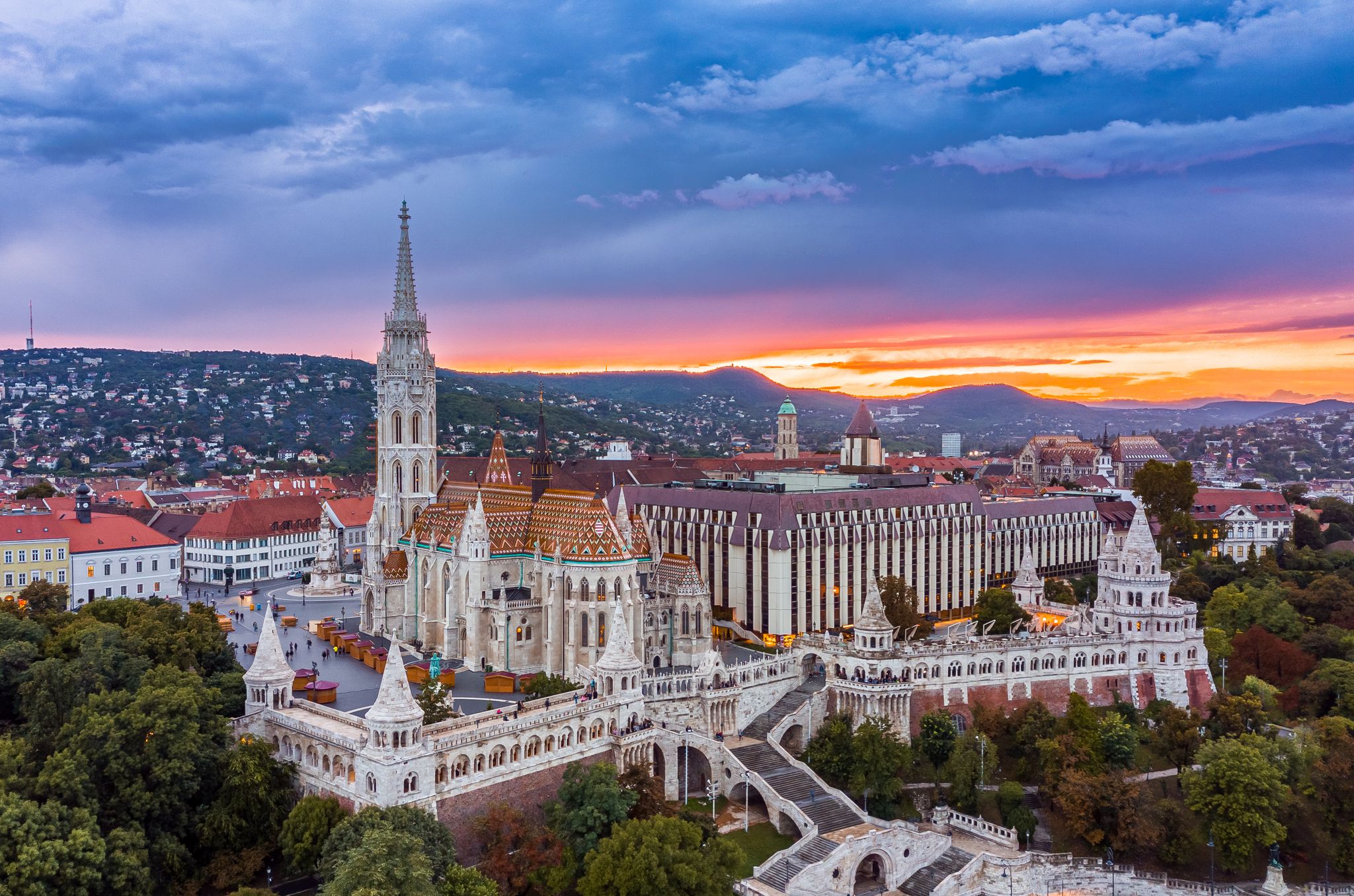 Photo of aerial panoramic skyline view of Budapest at cloudy sunset with Matthias Church(Mátyás Templom) and Fisherman's bastion (Halászbástya), Budapest, Hungary.