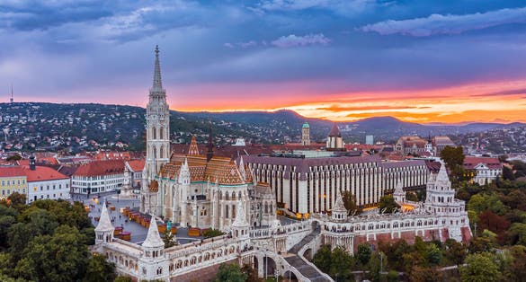Photo of aerial panoramic skyline view of Budapest at cloudy sunset with Matthias Church(Mátyás Templom) and Fisherman's bastion (Halászbástya), Budapest, Hungary.