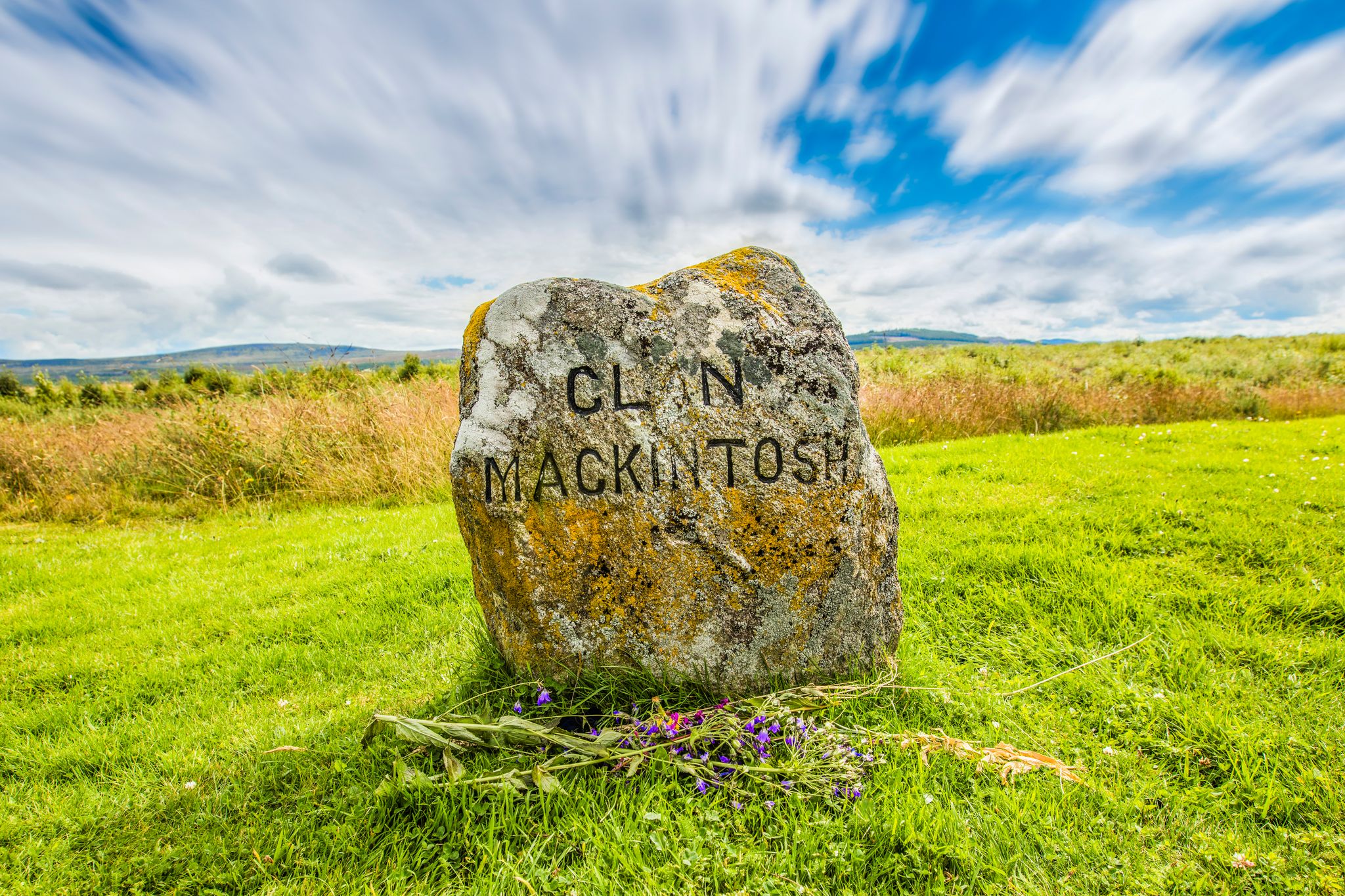 Clouds roll over a medieval gravestone for clan Mackintosh from the battle of Bannockburn.