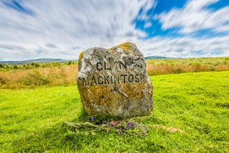 Clouds roll over a medieval gravestone for clan Mackintosh from the battle of Bannockburn.