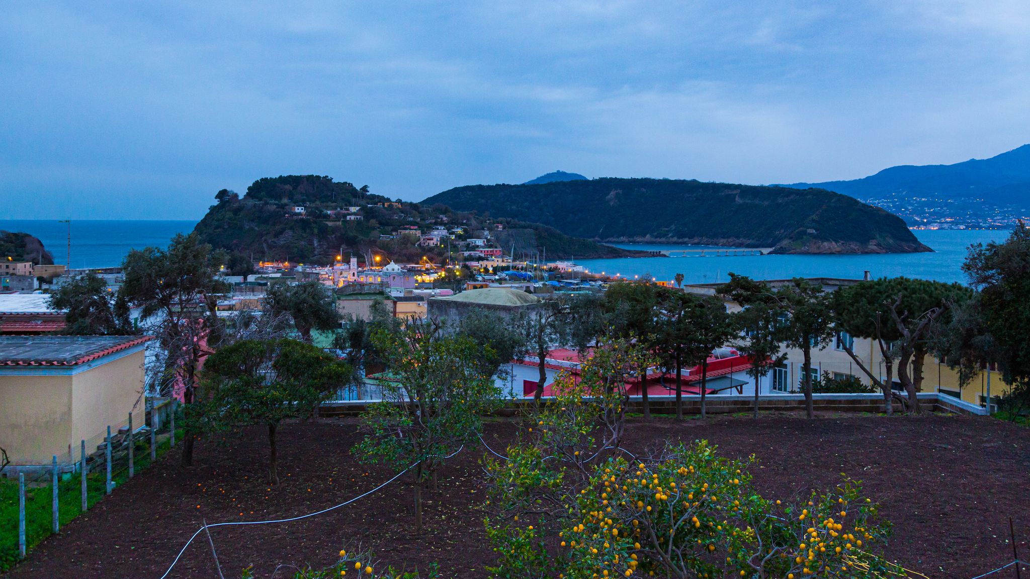photo of Procida (Napoli, Italy) - Night view of Ischia, Vivara and Chiaiolella bay .