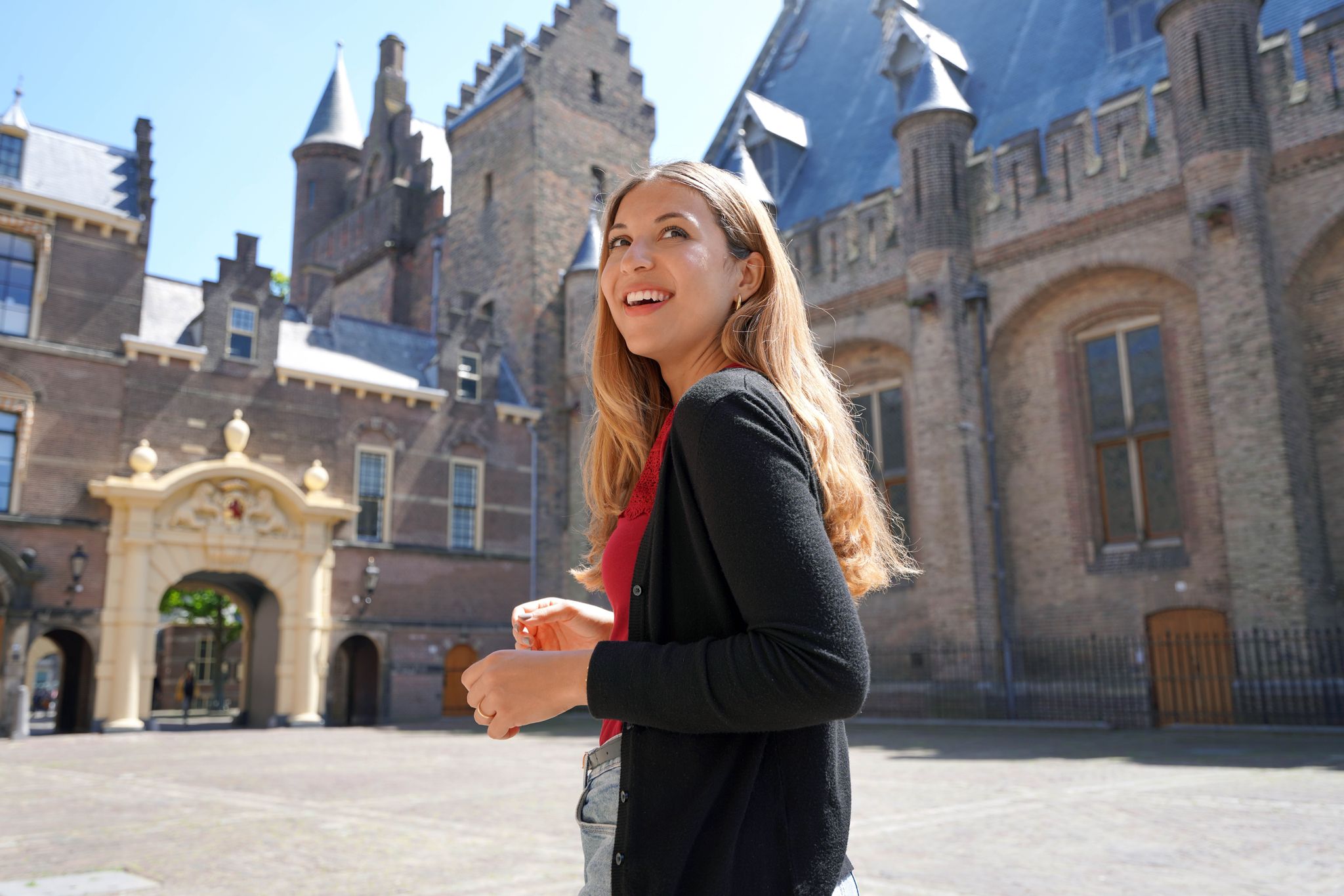 photo of young student girl visiting the complex of buildings of Binnenhof in the Hague, Netherlands.
