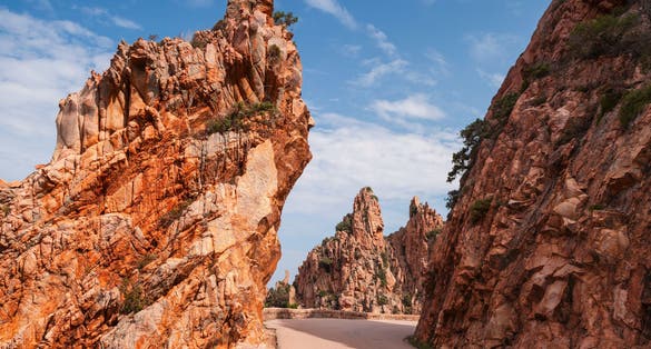 Photo of mountain road in Calanques de Piana. Corsican red rocks located in Piana, between Ajaccio and Calvi.