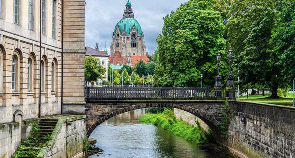 photo of view of New Town Hall or Neues Rathaus and the Leineschlossbrücke bridge over the river Leine in Hanover, Germany