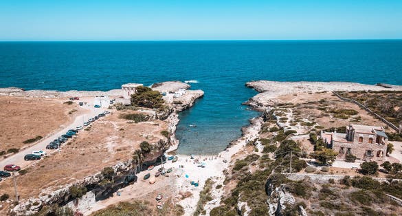 photo of  view ofAerial view of Cala Port'Alga near Torre Incina and Isola dell'Eremita in Polignano a Mare, in Puglia. Drone view of cliffs, coastline in Puglia and small island, near Monopoli, province of Bari.,Polignano a Mare Italy.