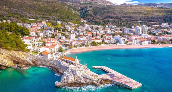 Town of Petrovac beach and coastline aerial view, archipelago of Montenegro