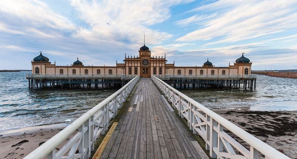 photo of Cold bath house, kallbadhuset, on poles on a beautiful morning by the beach in Varberg Sweden.