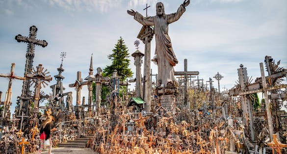 photo of Siauliai, Lithuania -July 18: Pilgrims visiting hill of crosses (kryziu kalnas) a famous religious landmark in Lithuania on July 18, 2015.