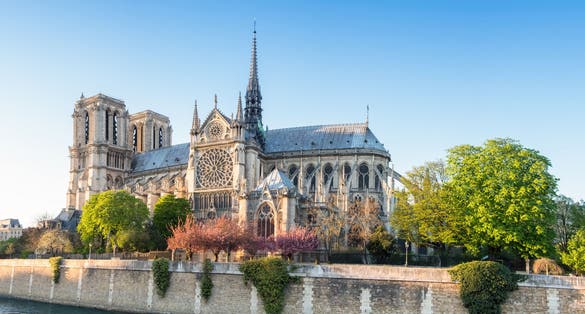 Photo of Notre Dame Cathedral in Paris on a bright afternoon in Spring, France.