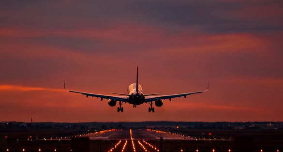 photo of view of Airplane landing at sunset on otopeni airport.