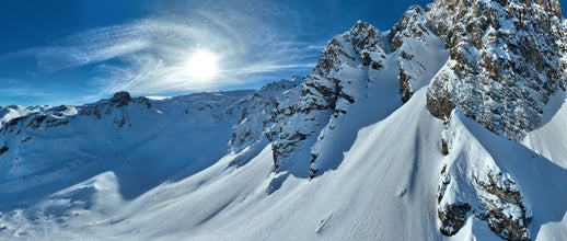 photo of winter drone shot of ski and slopes covered with fresh powder snow in Tignes in Val, Isere France.