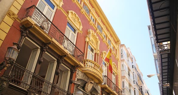 Photo of Looking up at the beautiful buildings & architecture lining La Calle Mayor. The street connects Plaza de España with the port with little shops, bars and restaurants. Cartagena, Murcia, Spain.