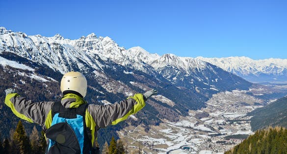 photo of a man in paragliding suit at Alp mountain, Innsbruck, Austria.