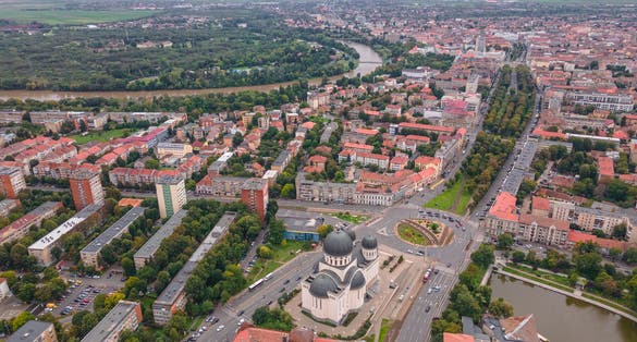 photo of view of Top view of Arad, Romania cityscape with the Orthodox Cathedral and the surounding buidings. Photography was shot from a drone at a higher altitude.