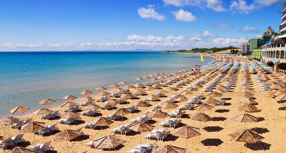 Photo of beautiful Sunny Beach with umbrellas and sunbeds in Nesebar, Bulgaria.