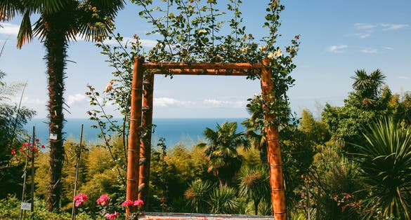 Photo of arch with palms and sea view in Rose Garden, Batumi.