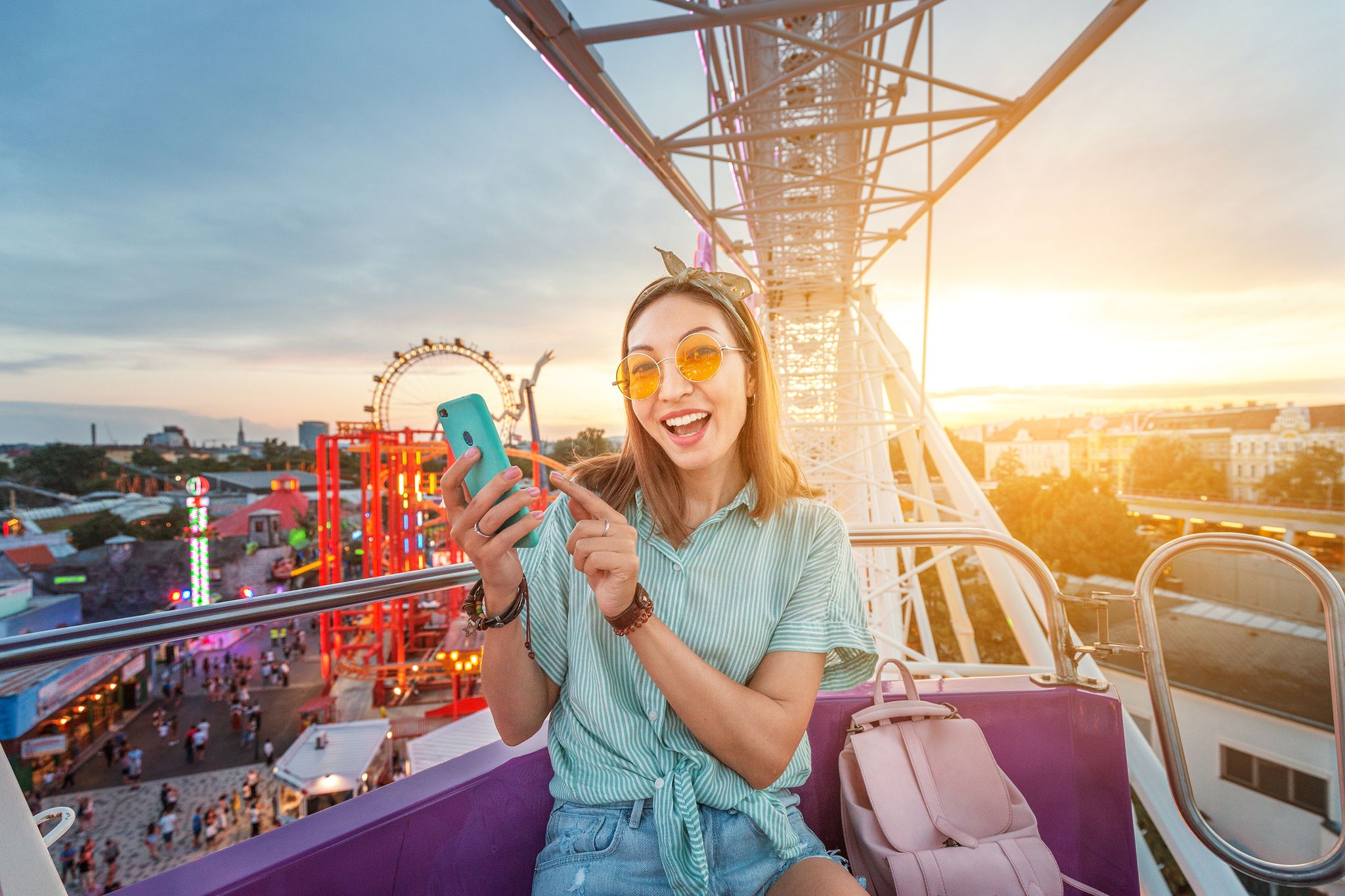Photo of happy tourist enjoying the Wiener Riesenrad or Vienna Giant Wheel 65m tall Ferris wheel in Prater park in Austria.