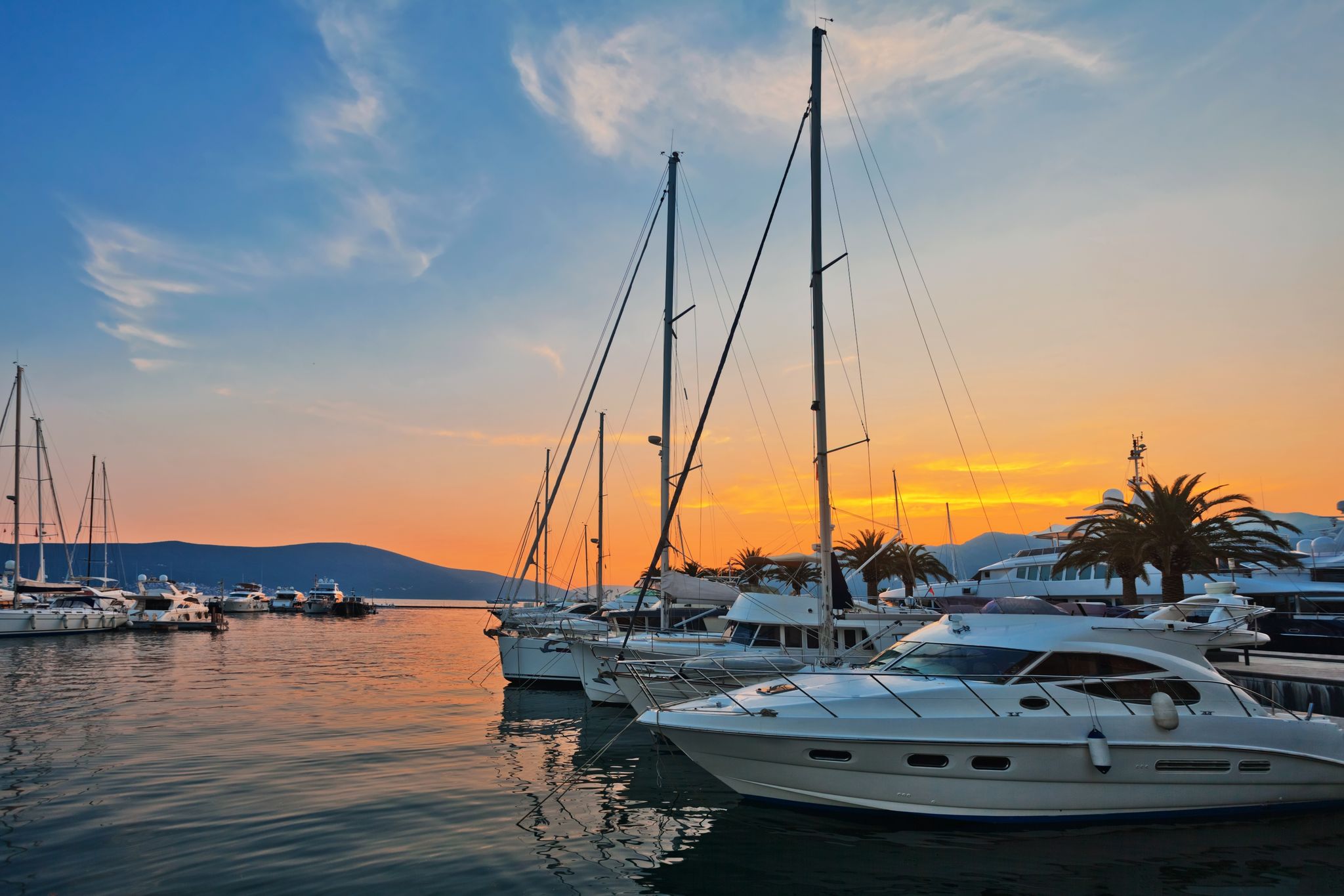 Photo of sailing boats in marina at sunset, Tivat, Montenegro.