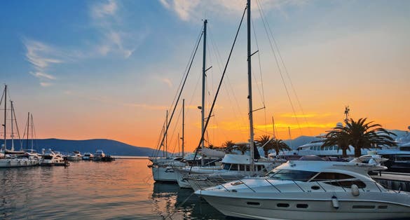 Photo of sailing boats in marina at sunset, Tivat, Montenegro.