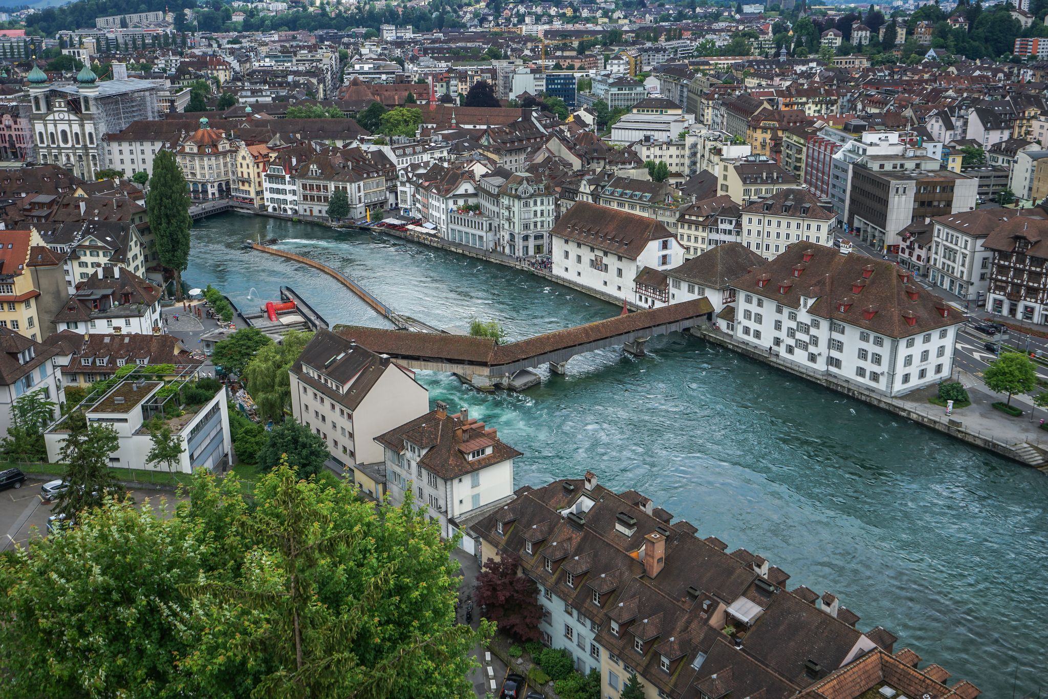 photo of the Musegg wall offers a panoramic view of River Reuss and wooden ancient Spreuer Bridge, Lucerne, Switzerland.