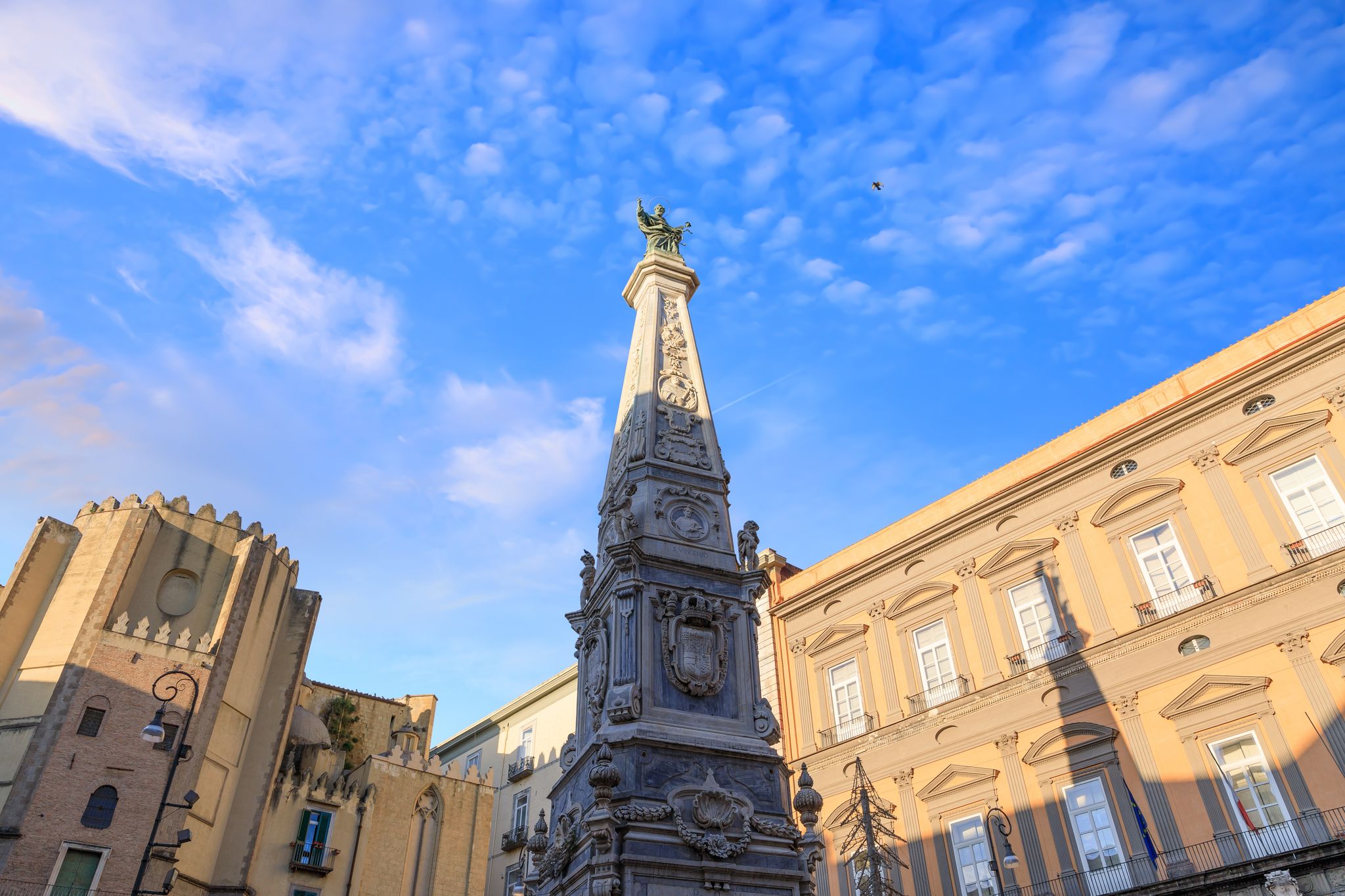 View of the Piazza San Domenico Maggiore, one of the most important squares in the historical center of Naples. It is dominated by the imposing marble obelisk of the San Domenico Maggiore.
