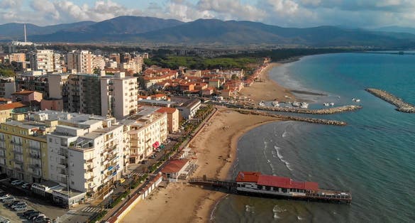 Panoramic aerial view of Follonica, Italy. Coastline of Tuscany with town and ocean.