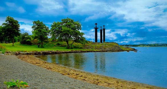 Photo of aerial view of three large swords Sverd i Fjell stand on the hill as a memory to the Battle of Hafrsfjord in year 872 in Stavanger, Norway.
