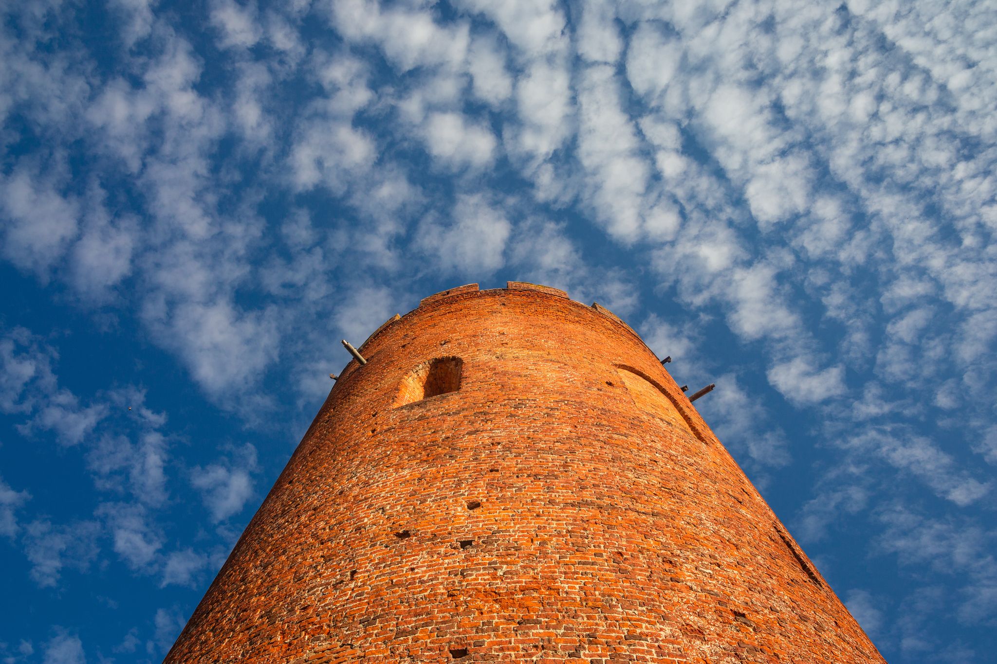 Photo of details of old Tower of Kamyenyets with blue sky, Belarus.
