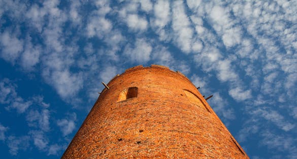 Photo of details of old Tower of Kamyenyets with blue sky, Belarus.