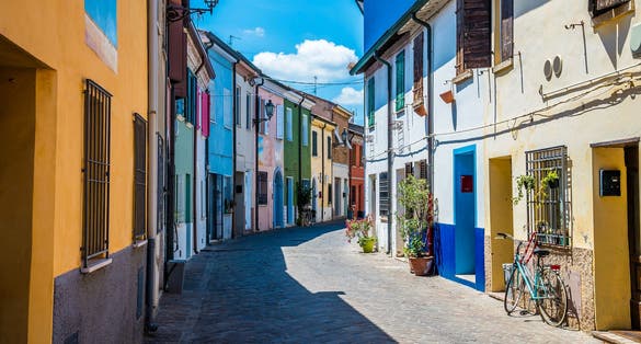photo of view of A view down a colourful street in the village area of San Giuliano in Rimini, Italy in summertime