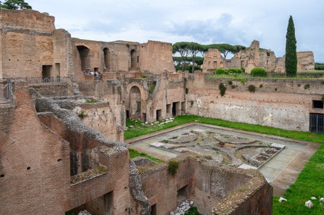 House of Augustus on Palatine Hill, Rome, Italy. Famous Palatine is tourist attraction of Rome. Ancient Roman buildings and ruins on Palatine top in summer. Theme of old palace, travel and tourism.