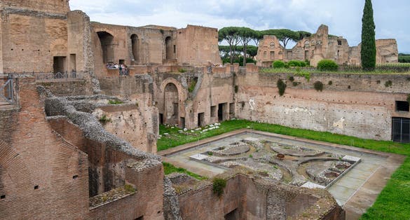 House of Augustus on Palatine Hill, Rome, Italy. Famous Palatine is tourist attraction of Rome. Ancient Roman buildings and ruins on Palatine top in summer. Theme of old palace, travel and tourism.