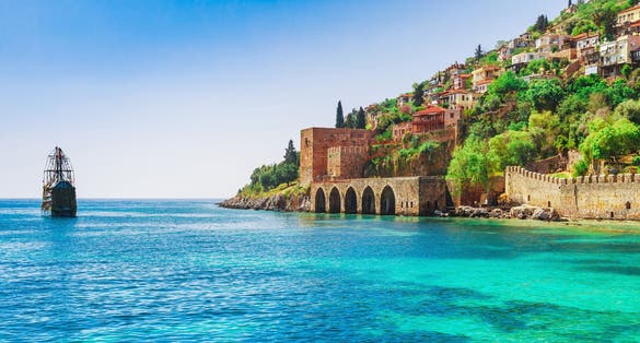 Shipyard and ship near Kizil Kule Red tower in Alanya, Antalya, Turkey