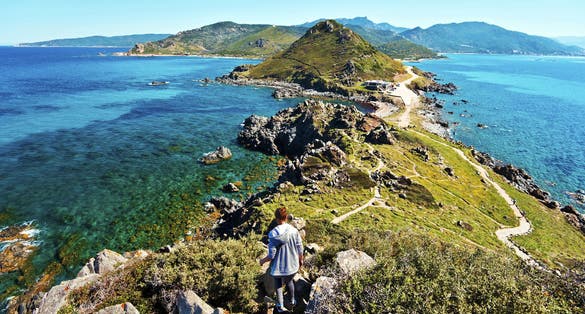 Photo of Young Girl walk down from Genoese Tower of Parata peninsula, Ajaccio.