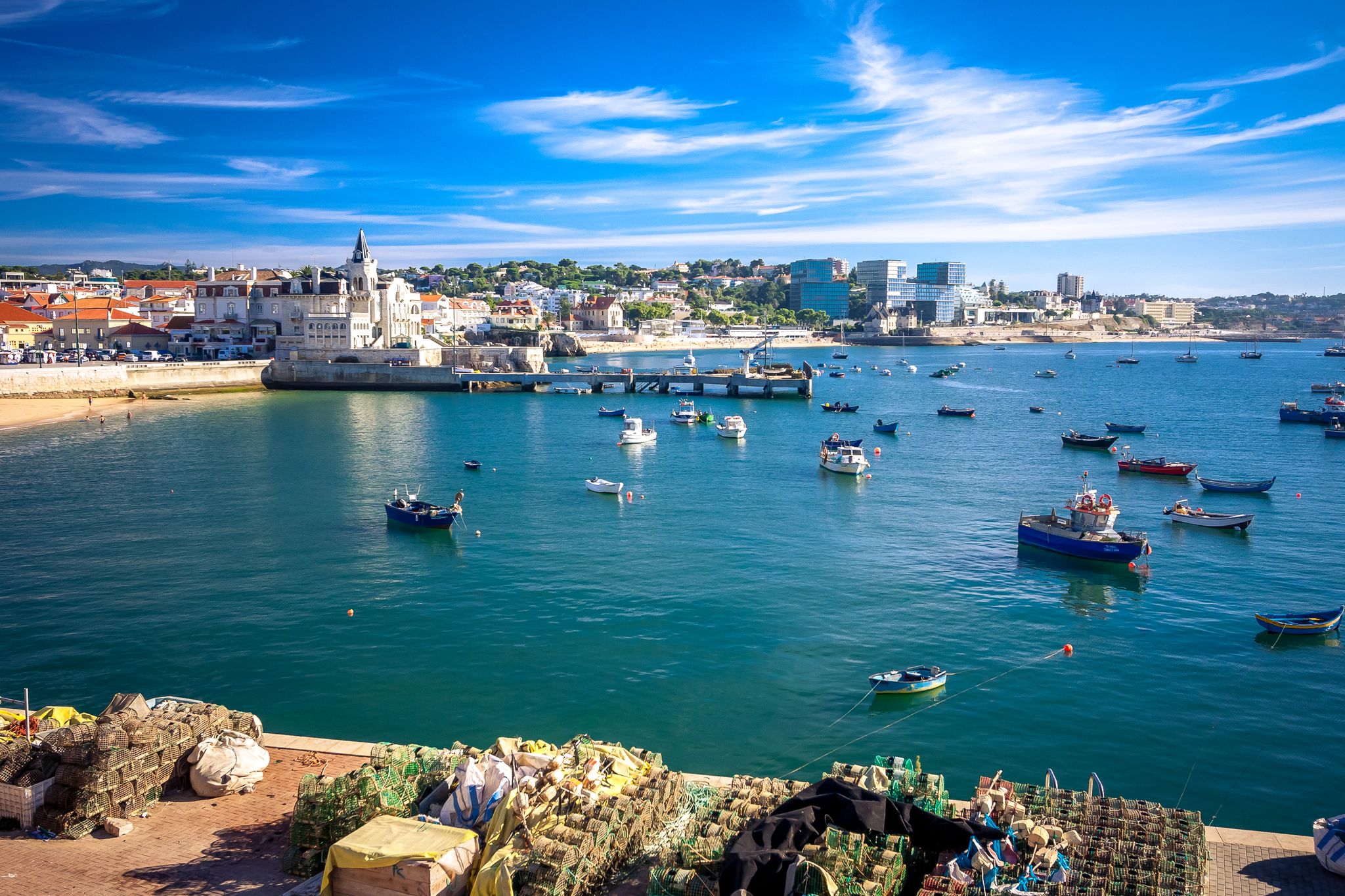 Photo of aerial view over People Crowd Having Fun On Beach And Over Cascais City In Portugal.