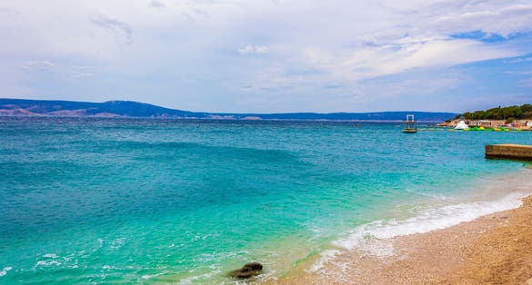 Wonderful sand and rocky beach and promenade in Novi Vinodolski Croatia.