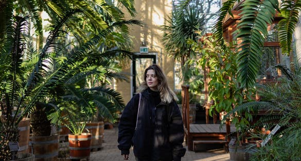 photo of young woman in Hortus Botanicus in Amsterdam, Netherlands.