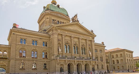 photo of people visiting Bundesplatz the Swiss Capital Building in Bern, Switzerland.