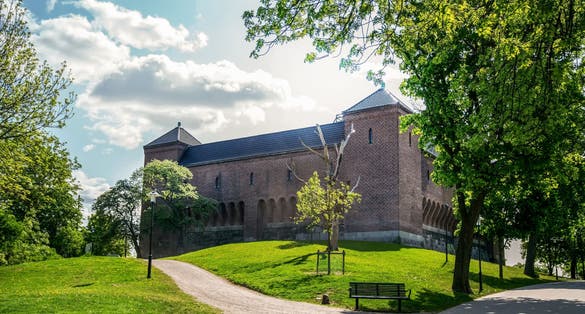 photo of old Vanadislunden reservoir (brick building on hill) in sunny fantastic may day in park Vanadislunden of Stockholm, Sweden.