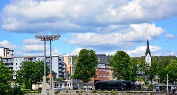 photo of view of View of the port of Hamar, Norway, from Lake Mjosa with the Bell tower and the tower of Hamar Cathedral. Hamar is a small town in Innlandet, formerly Hedmark, county.