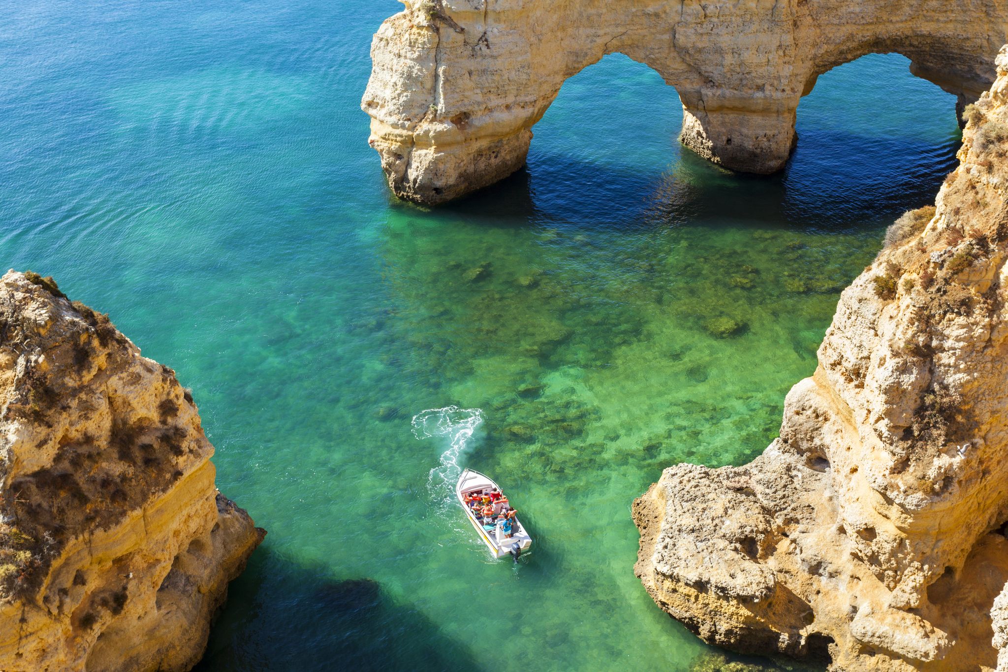 Photo of wide sandy beach in white city of Albufeira, Algarve, Portugal.