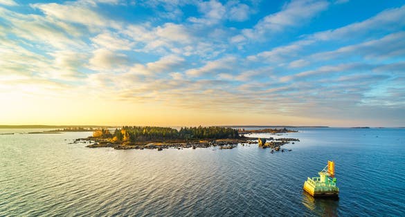 Beautiful sunrise scenery of an island in the Finnish archipelago in Vaasa, Shot from the Ferry connection between Vaasa and Umea.