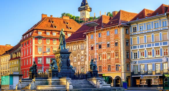 Photo of facades and the clock tower in the old town of Graz, Austria.