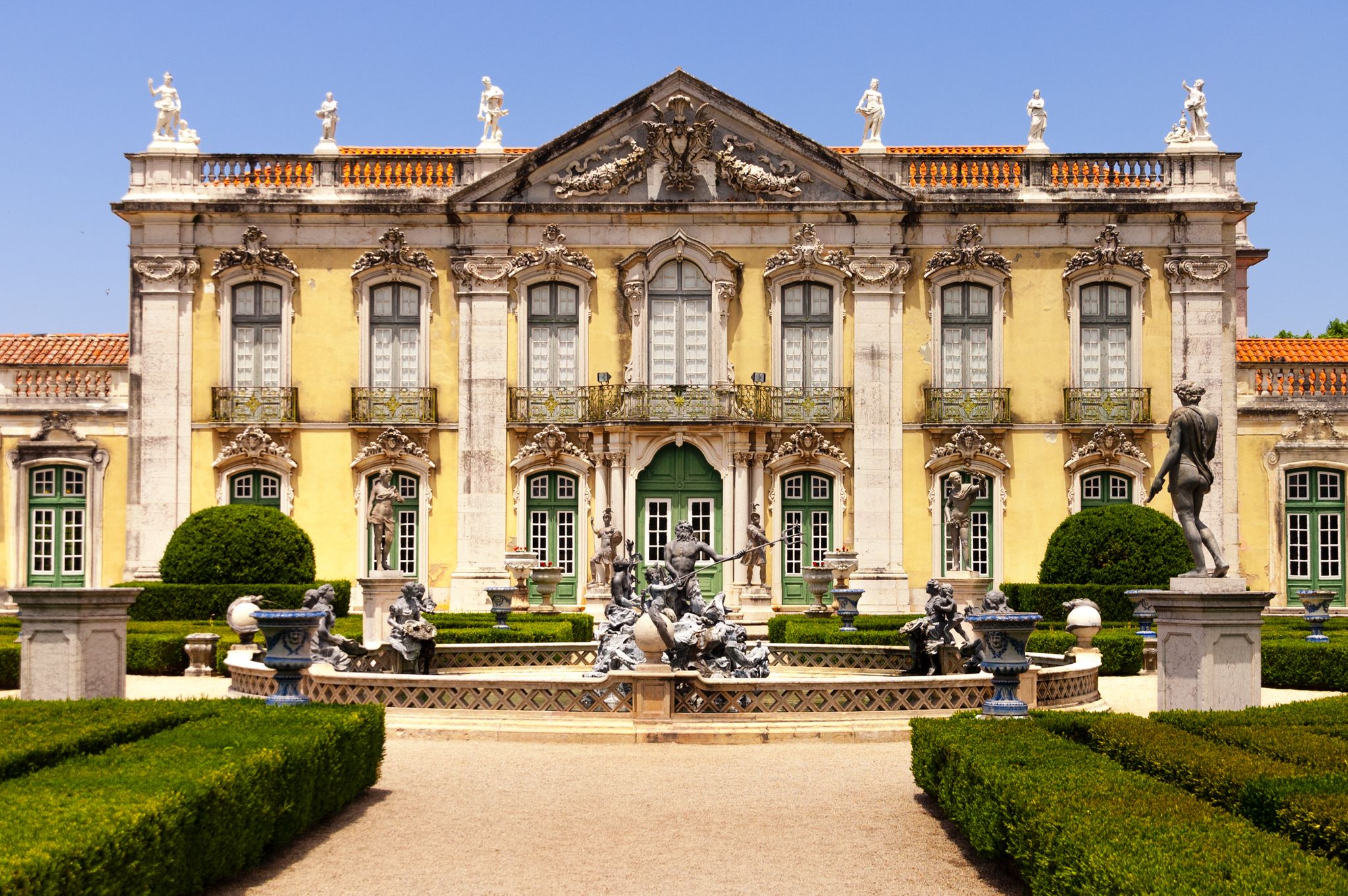 Photo of Facade and garden of Queluz National Palace with Neptune's fountain, in Sintra, Lisbon district, Portugal.