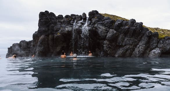 photo of Reykjavik, Iceland - July 17 2022: Sky lagoon in Iceland. Tourists enjoying geothermal spa with heated water during cold day.