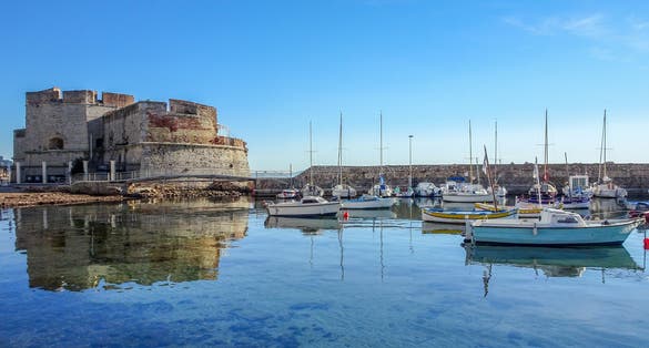 Photo of reflections in the water around the Fort at Toulon, France.