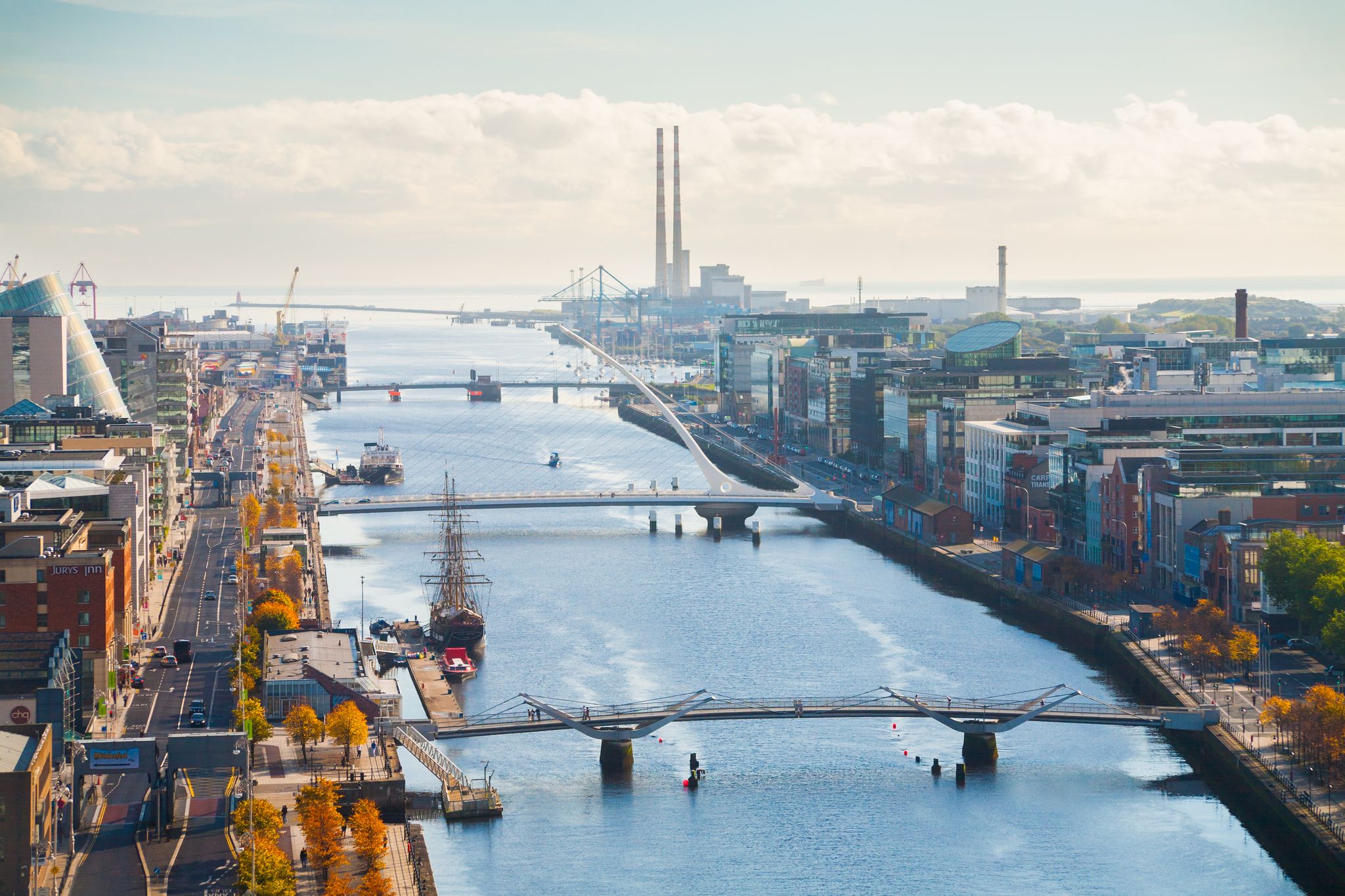 Aerial view of Dublin city center at sunset with River Liffey and Samuel Beckett bridge in the middle. Bridge designed by Santiago Calatrava.
